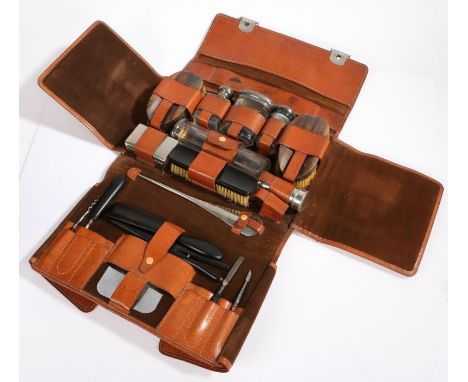 Asprey London, a gentleman's Art Deco brown leather travelling vanity case, embossed T.F.C. enclosing a suede lined fitted in