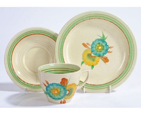 Clarice Cliff Wilkinson Ltd. trio, the ribbed bodies with brown and green banded decoration, the cup and side plate with foli