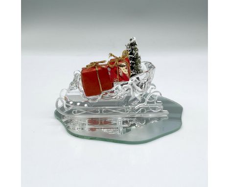 Clear crystal figure of a sleigh with two presents and a tree inside. Swarovski mark. This item has its original box: 5.75"H 