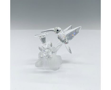 This Swarovski crystal hummingbird, part of the Feathered Beauties theme, features the hummingbird and flowers crafted from c