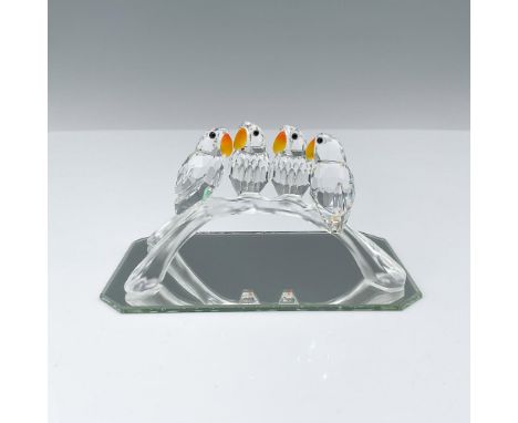 Four clear faceted crystal birds are gracefully perched on a frosted arched branch, each adorned with fire opal crystal beaks