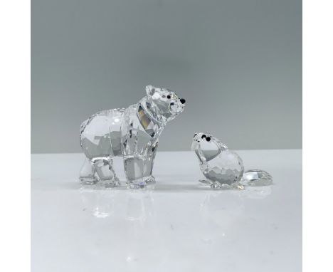 Polar Bear 1079156 and Beaver 164638. A clear polar bear with crystal eyes standing gracefully with its head turned curiously