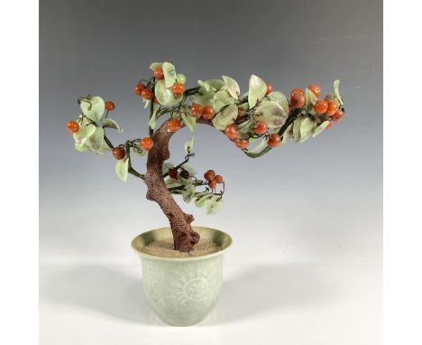 Delicate Chinese jade tree adorned with light green stone leaves and vibrant red stone cherries. Presented in a celadon-color