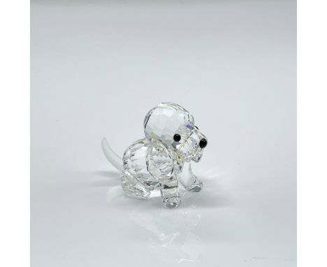 Clear faceted crystal figure of a seated puppy with black eyes and nose, frosted tail. Swarovski etched mark. This item has i
