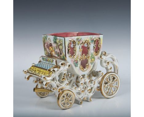 Large original hand painted porcelain carriage coach. The interior is colored in light pink and the exterior features soft ba