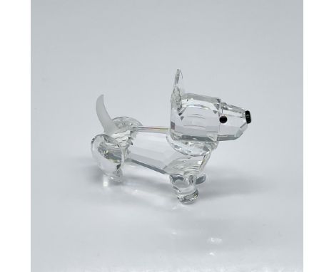 Clear-cut crystal figure depicting a dog standing and gazing forward, radiating sparkling brilliance. This item has its origi