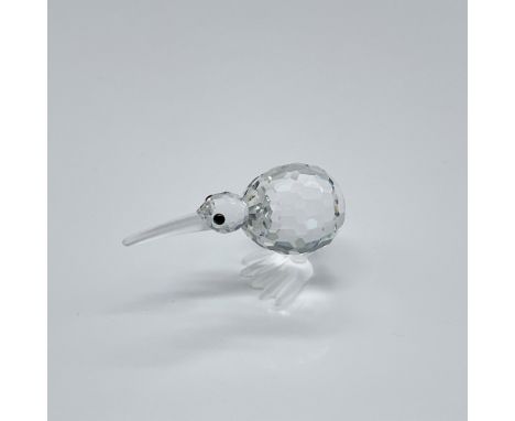 A clear crystal figure of a kiwi stands upright, facing forward, with black crystal eyes and frosted crystal feet. Swarovski 