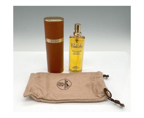 Gold toned leather case holds glass perfume bottle. Cloth bottle cover included. Hermes Paris impressed mark. This item has i