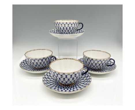 Hand painted royal blue over white porcelain in a fishnet pattern with gilt accents in design and on rim. Set includes 4 cups