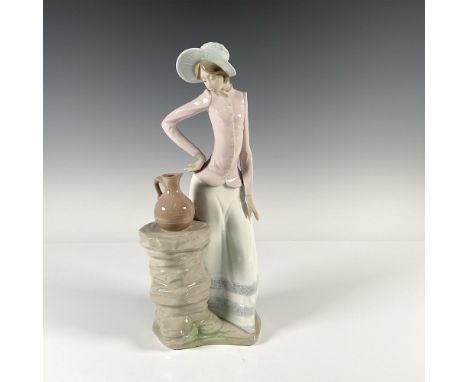 Woman eyeing a pitcher sitting on a stone pedestal. Gloss finish. NAO backstamp. Issued: 20th centuryDimensions: 4"L x 5.25"W