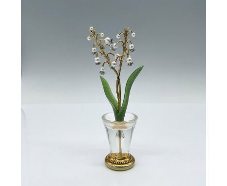 This small decorative flower is adorned with hand-set simulated pearls, meticulously crafted to resemble the delicate white b