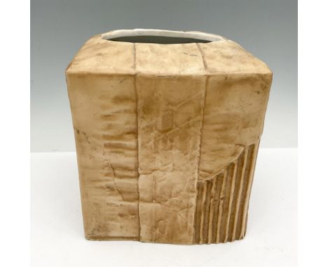 Creative tissue box holder made to look like cardboard with Corrugated Recycles stamped on side, torn carton sides and Fragil
