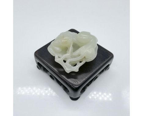 A beautifully hand carved stone featuring two cats resting on a large leaf. This item has a base included: 3"L x 3"W x 1"H. I