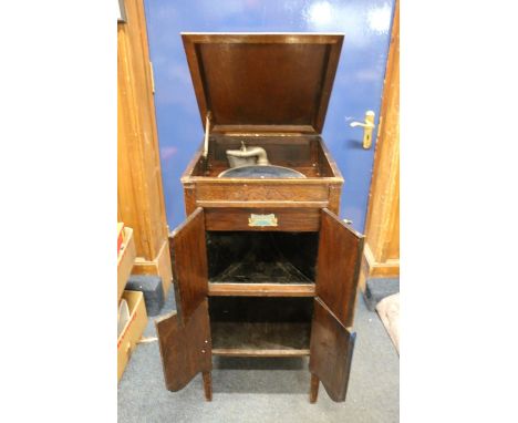 Fitonal antique record player cabinet and a collection of antique records. 