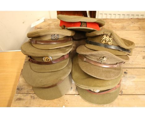 Seven British Army peaked caps to include one with George V Royal Engineers cap badge and interior label 'George Downle &amp;