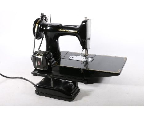 Singer model 222K sewing machine, numbered to the base 'EM602093', in original case. This lot will be sold on Thursday April 