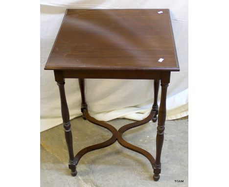 A mahogany lamp table on turned legs and cross stretchers