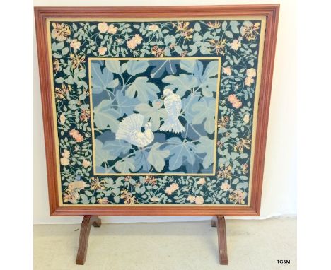 An embroidered fire screen on twin feet 120 x 110cm