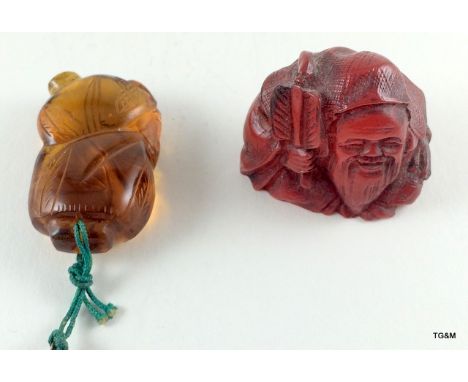 An Amber carved Netsuke with sign on base and carved Amber figure