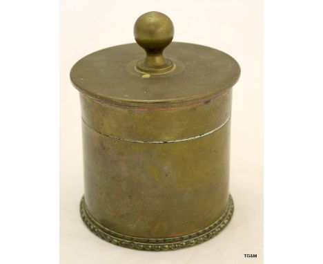 A WW1 trench art lidded tea caddy or tobacco jar made from a cut down 13 pounder shell case dated 1916