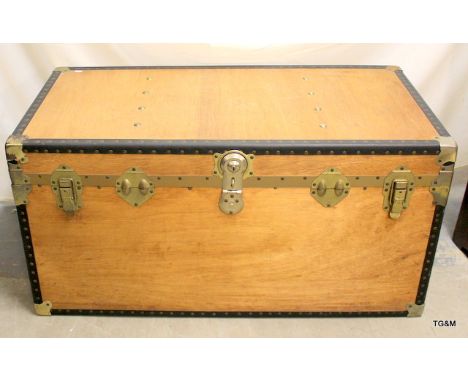 A metal bound wooden travel trunk manufactured by over pold 110 x 55 x 55cm