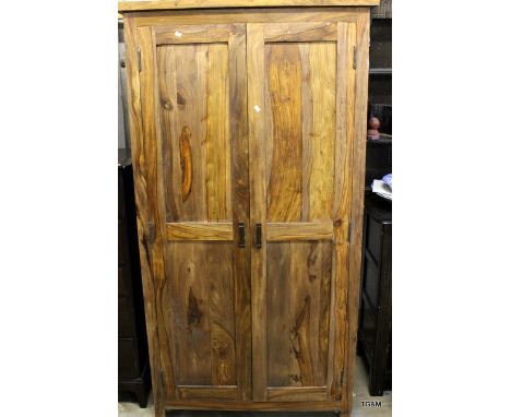 A hardwood wardrobe with shelf and hanging rails