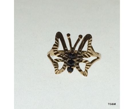 A ladies 9ct gold butterfly ring set with sapphires size k