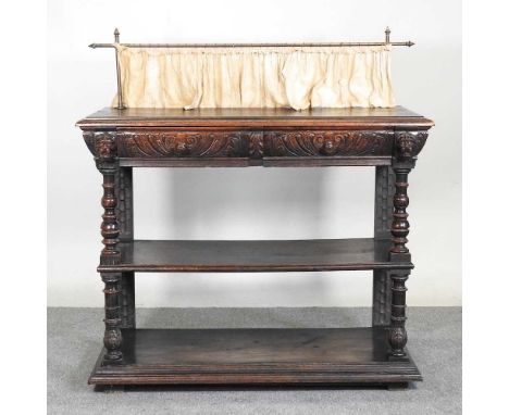 A 19th century continental carved oak three tier buffet, with a brass gallery back and mask decoration121w x 56d x 129h cm