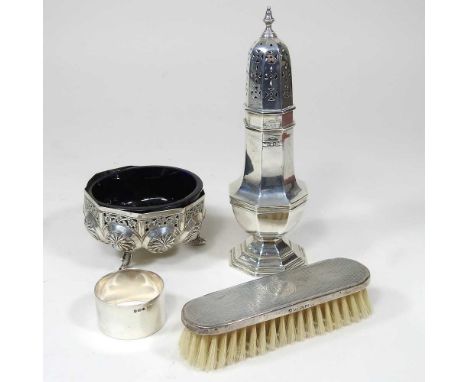 A silver sugar caster, 17cm high, together with a silver napkin ring, 146g gross, together with a silver backed brush and pie