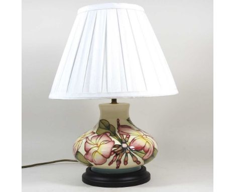 A Moorcroft pottery table lamp, decorated in the Pink Magnolia pattern, with a cream shade, 41cm high overallOverall conditio