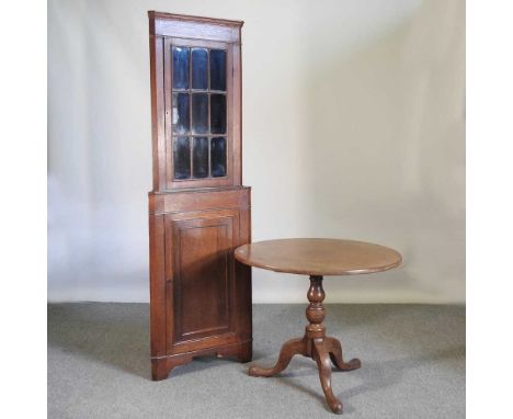 A George III mahogany occasional table, on a tripod base, 87cm diameter, together with an oak standing corner cabinet, 197cm 