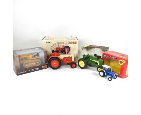 An Ertl Tractors of the Past Case 600 model tractor, together with a Norscot Caterpillar, a John Deere model 630 and a Britai