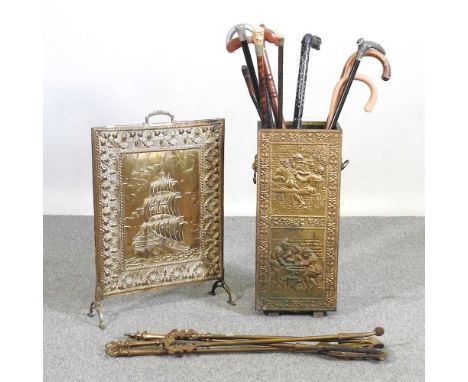 A brass stick stand, containing a collection of novelty walking sticks, to include Indian and horn handled examples, together