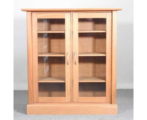 A modern light oak glazed cabinet, on a plinth base107w x 40d x 115h cm