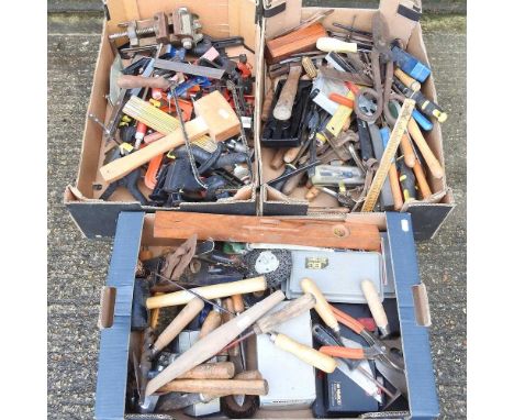 A collection of various hand tools and garden trugs