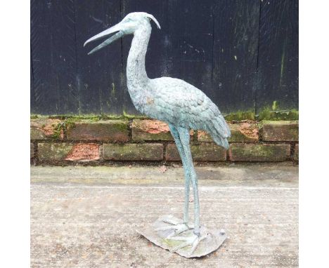 A bronzed garden model of a heron, 62cm high