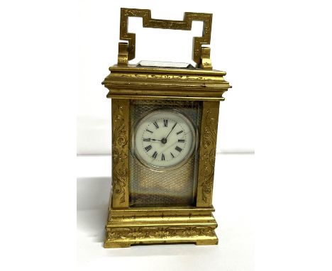 Miniature antique carriage clock, the outer brass body extensively engraved 