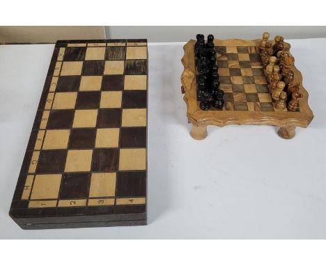 two wooden chess boards with pieces 