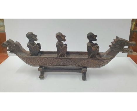 Large wooden hand-carved antique Indonesian canoe with rowers on original matching wood stand,60cm long 