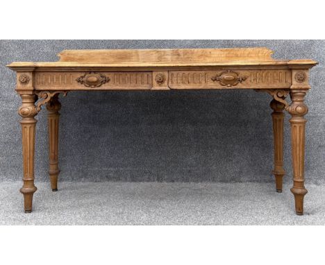 A late Victorian carved oak console or serving table fitted with frieze drawers raised on fluted tapering supports. H.87 W.16