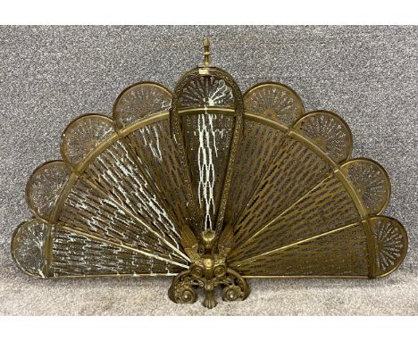 A vintage brass articulated peacock fire screen. H.61 W.95cm 