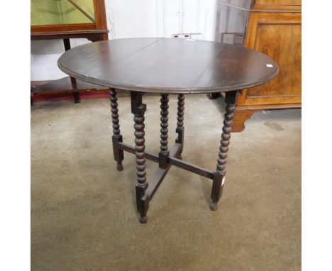 An oak bobbin turned folding table/firescreen 