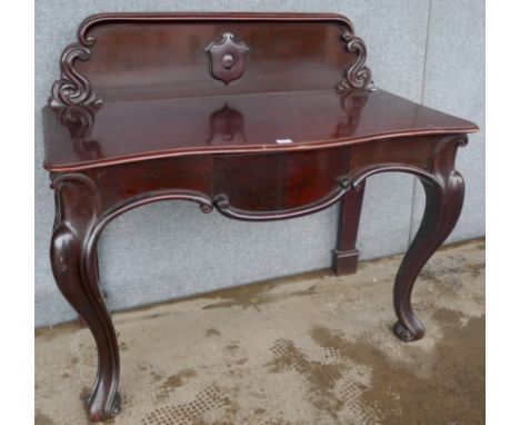 A Victorian mahogany serpentine single drawer console table 