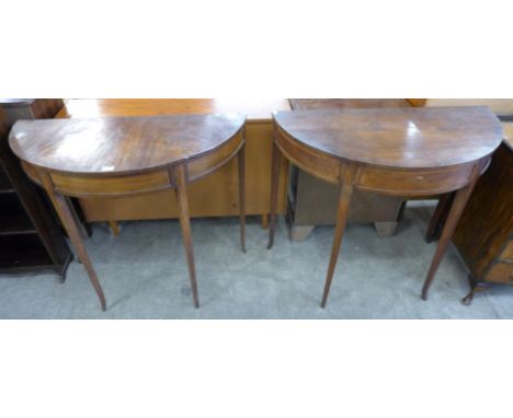 A pair of George III mahogany demi-lune console tables 