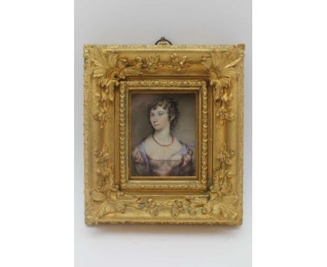 AN EARLY 19TH CENTURY MINIATURE PORTRAIT WATERCOLOUR PAINTING, a young woman, her in ringlets, 8cm x 6.5cm, in an ornate gilt