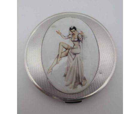 R. DAVIS &amp; CO. A SILVER POWDER COMPACT, circular for, the cover inset an oval enamel panel depicting a pin-up girl, engin