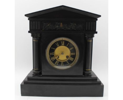 A LATE VICTORIAN BLACK SLATE MANTEL CLOCK of Architectural classical form, with embossed frieze and column mounts, black dial