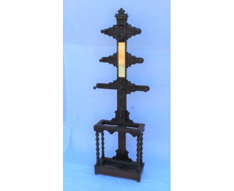 A PROBABLE 19TH CENTURY CARVED WOODEN FREESTANDING HAT &amp; COAT RACK, with central plain insert mirrored panel, carved with