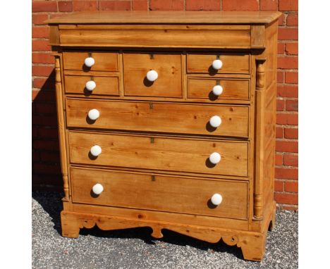 A 19TH CENTURY POSSIBLE SCOTTISH PINE CHEST having full width cushion fronted top drawer, over two hat box drawers and two fu