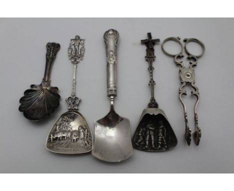 A PAIR OF CAST GEORGIAN SILVER SUGAR TONGS, together with a silver tea caddy spoon, Birmingham 1826, and three other shovels,